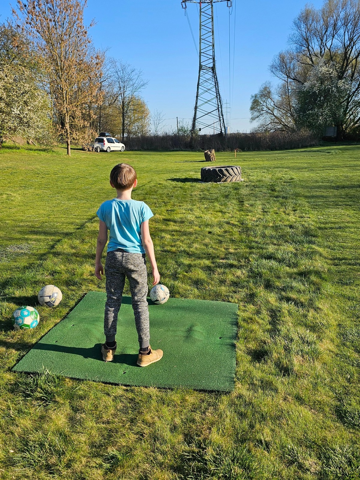 Syn kope míč na hřišti